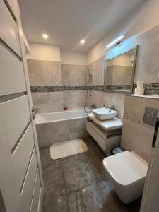 a bathroom with a sink and a toilet and a tub at marius in Chiajna +8 photos