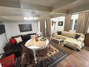 a living room with a couch and a table at Nature Paradise Apartment in Karditsa