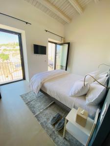 a bedroom with a bed and a large window at Tantillo Cinque in Modica