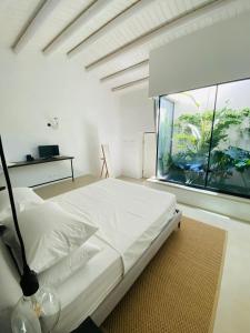 a bedroom with a bed with an aquarium in the window at Tantillo Cinque in Modica +31 photos