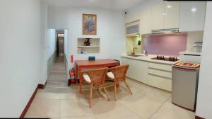 a kitchen with a table and two chairs in it at Chongguang Hotel in Tainan