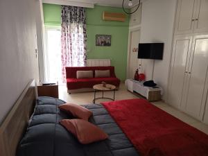 a living room with a couch and a red couch at Sroom Karditsa in Karditsa