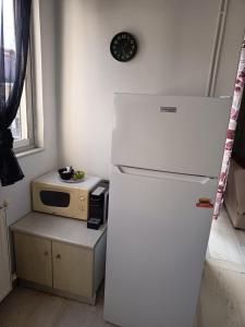 a white refrigerator in a kitchen with a microwave at Sroom Karditsa in Karditsa +18 photos