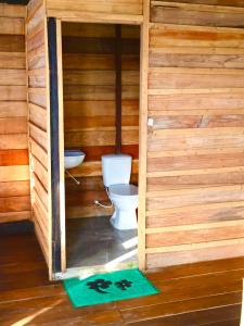 a wooden bathroom with a toilet and a sink at Reserva Natural Natura Park in Loreto Mocagua +119 photos