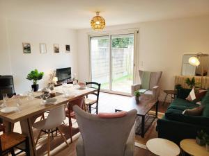 a living room with a table and a couch at Ernest Lodge Angers in Angers