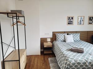 a bedroom with a bed and a dresser with a night stand at Ernest Lodge Angers in Angers