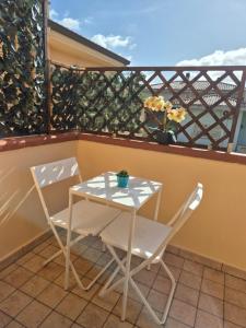 a table and two chairs on a balcony at Da Luca in Càbras +3 photos