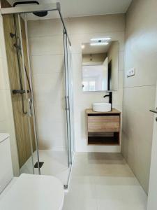 a bathroom with a shower and a sink at RÍA LIVING - Calma 02 in Cee +15 photos