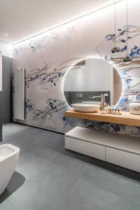 a bathroom with a sink and a toilet and a mirror at Realkasa Kairos Luxury Apartments in Bologna +123 photos