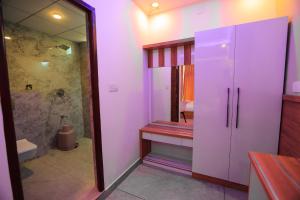 a bathroom with a walk in shower and a toilet at By the stream resort wayanad in Padinjarathara
