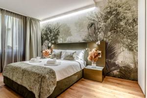 a bedroom with a large bed and a painting on the wall at Realkasa Kairos Luxury Apartments in Bologna