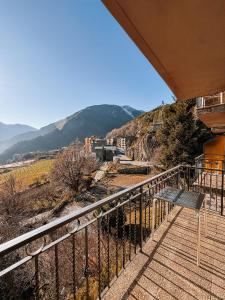 a balcony of a building with a bench on it at Hotel La Burna Panoràmic in Sispony