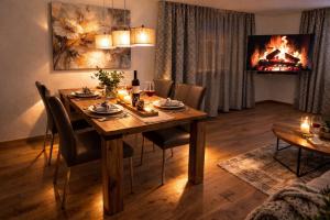 a dining room with a table and a fireplace at Casa Ladina 2 in Falera