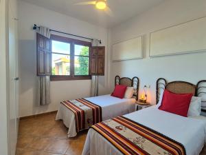 two beds in a room with a window at Villa Florida in Motril +29 photos