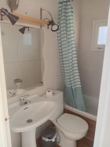 a bathroom with a sink and a toilet and a shower at Hostal Collsacabra in L’ Esquirol +11 photos