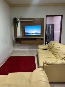 a living room with two couches and a flat screen tv at Casa AGV 77 - Gaibu Beach in Cabo de Santo Agostinho