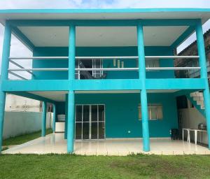 a blue building with blue columns and a patio at Casa AGV 77 - Gaibu Beach in Cabo de Santo Agostinho