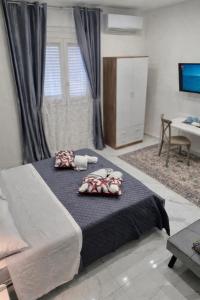 a bedroom with a bed with two pillows on it at Dolce Giò A in Mazara del Vallo