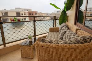 a balcony with wicker chairs and a table on a balcony at Kaz An Nou in Cotonou