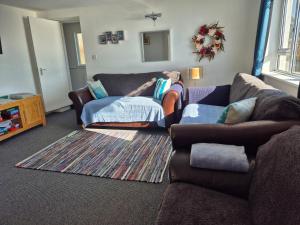 a person laying on a couch in a living room at Firthview House great for families with children pet friendly in Kirn