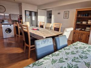 a kitchen and dining room with a table and chairs at Firthview House great for families with children pet friendly in Kirn