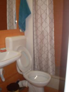 a bathroom with a toilet and a sink at apartament MIHAI in Mangalia +8 photos