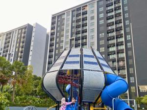 two children playing on a playground in a city at Elevé Gamuda in Banting