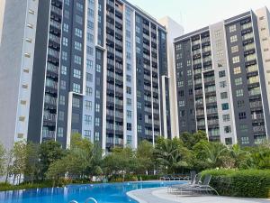 a pool in front of two tall buildings at Elevé Gamuda in Banting