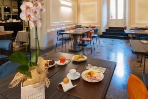 a table with food on it in a restaurant at Hotel Patria in Pistoia