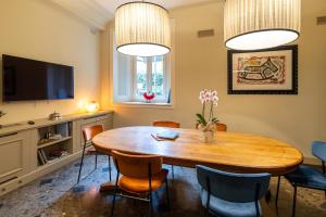 a dining room with a wooden table and chairs at Hotel Patria in Pistoia