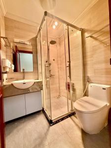 a bathroom with a shower and a toilet and a sink at IL Divo Hostel 8 Hàng Đào & Travel & Spa - Hanoi Old Quarter in Hanoi +116 photos