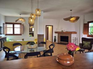 a dining room and living room with a table and chairs at Villa Florida in Motril