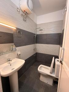 a bathroom with a sink and a toilet at 2BR luxury Apartment in Mount Lavinia - Benetia Stay in Mount Lavinia +4 photos
