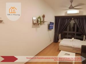 a living room with a bed and a tv at Elevé Gamuda in Banting