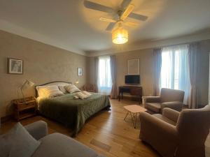 a bedroom with a bed and a ceiling fan at La Casa Occitane in Marseillan