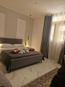 a bedroom with a bed with two stuffed animals on it at Dolce Giò A in Mazara del Vallo