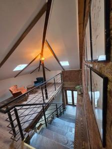 a staircase in a loft with a glass railing at MariaApartments in Bitola