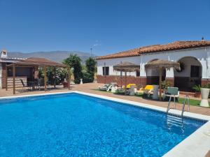a villa with a swimming pool and a house at Villa Florida in Motril