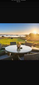 a table and chairs with a bowl on top of it at Birchall Lodge in Galway