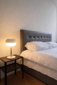 a bedroom with a bed and a table with a lamp at The Corner House in Delčevo