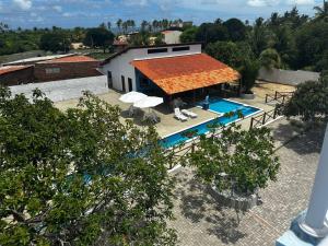 an overhead view of a house with a swimming pool at Pousada Encantos do Mar in Barra de Camaratuba