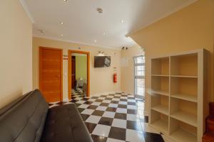 a living room with a couch and a checkerboard floor at DownTown Guest House in Lisbon
