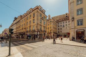 a busy city street with people walking on the street at DownTown Guest House in Lisbon