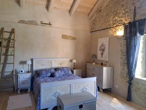 a bedroom with a bed and a dresser and a ladder at La Vita è Bella in Somano