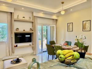 a dining room with a table with a bowl of fruit at Villa Sunray Sidari with private pool by DadoVillas in Sidari
