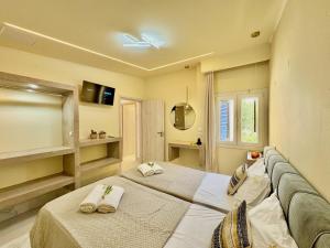 a bedroom with two beds with towels at Villa Sunray Sidari with private pool by DadoVillas in Sidari +23 photos