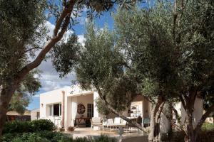 a white house with trees in front of it at La Dimora del Pensatore - country escape Noto in Canicattini Bagni