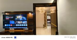 a living room with a large television in a room at Hotel Velina in Dhāmpur