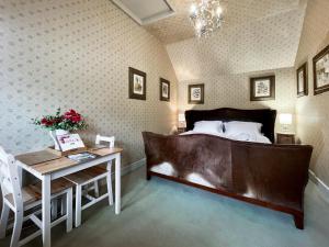 a bedroom with a bed and a table and a desk at Cottage 1 - Uk46611 in Broughton