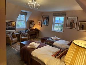 a bedroom with two beds and a desk and a room at Clachan Garden B&B in Garve